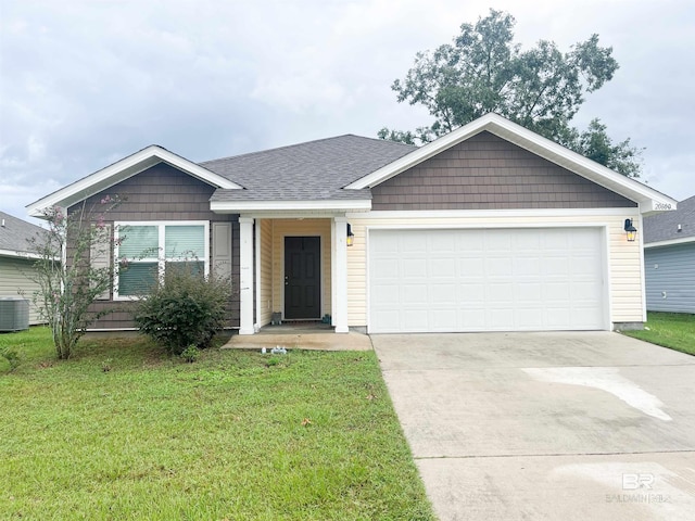 ranch-style house with a front yard, central air condition unit, and a garage