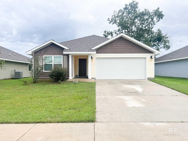 ranch-style house featuring a garage, central AC unit, and a front yard