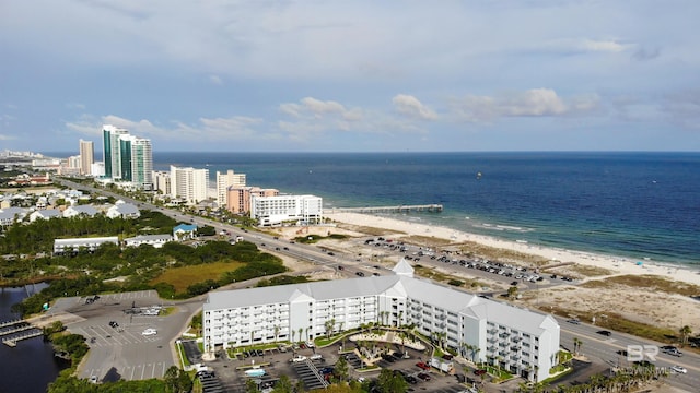 birds eye view of property featuring a water view and a beach view