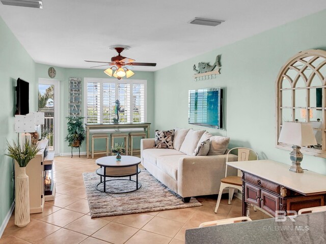 tiled living room with ceiling fan