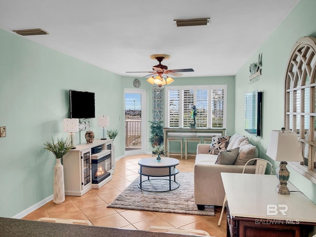 living room with ceiling fan and light tile patterned floors
