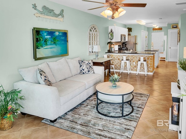 tiled living room featuring ceiling fan