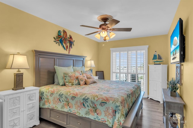 bedroom with ceiling fan and dark hardwood / wood-style floors