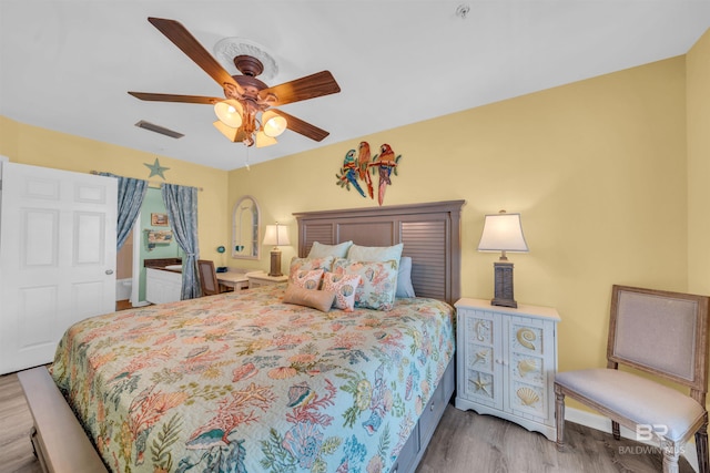 bedroom with ceiling fan and light hardwood / wood-style floors
