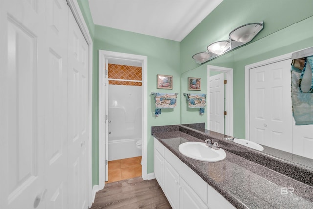 full bathroom featuring vanity, shower / washtub combination, toilet, and wood-type flooring