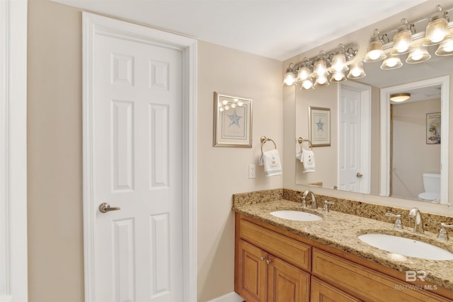 bathroom featuring toilet and vanity