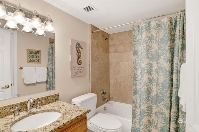 full bathroom featuring toilet, vanity, and shower / bath combo with shower curtain