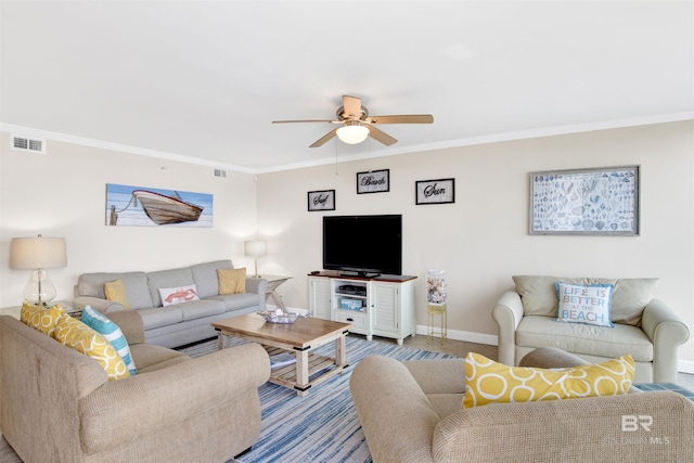 living room with ceiling fan and ornamental molding