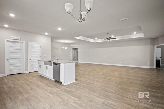 kitchen with light hardwood / wood-style flooring, light stone countertops, sink, a center island with sink, and stainless steel appliances