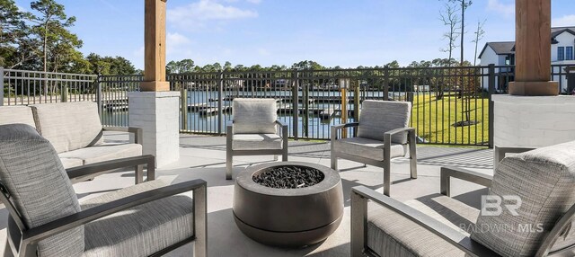 841 Inlet Cir, Gulf Shores, AL 36542 - view of patio with a dock, a fire pit, and a water view