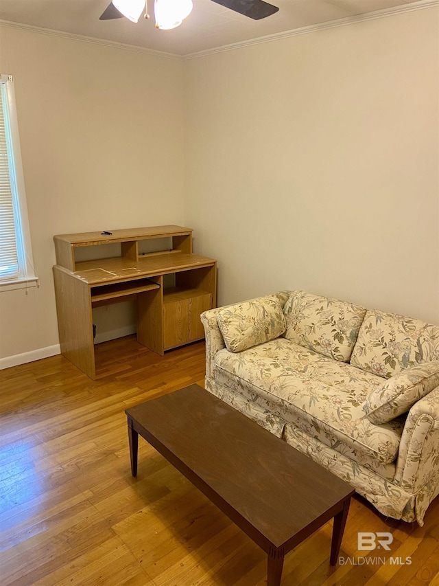 sitting room featuring ceiling fan, crown molding, and light hardwood / wood-style floors