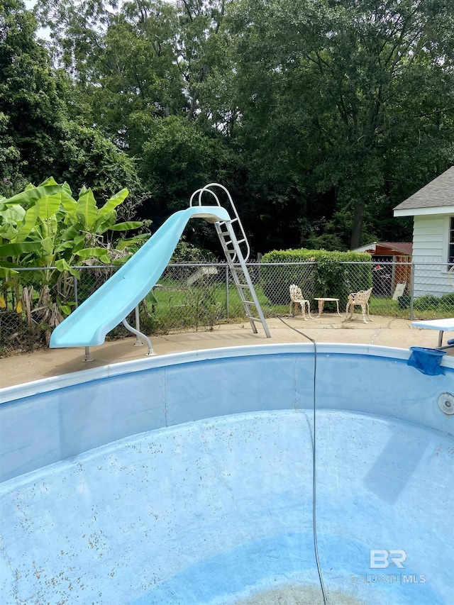 view of pool with a water slide