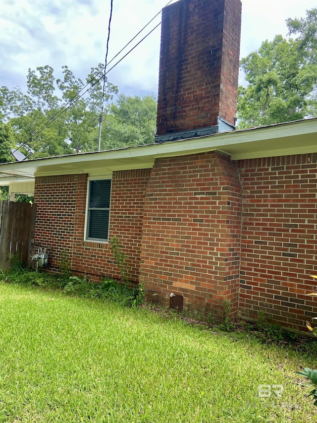 view of side of home with a lawn