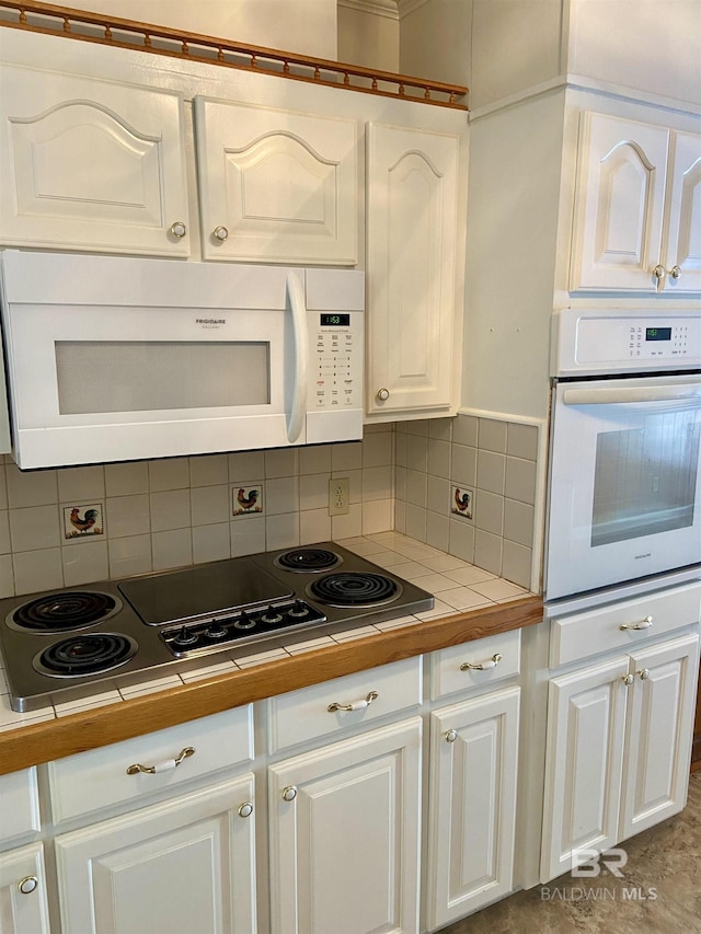 kitchen featuring white cabinetry, tile counters, tasteful backsplash, and white appliances