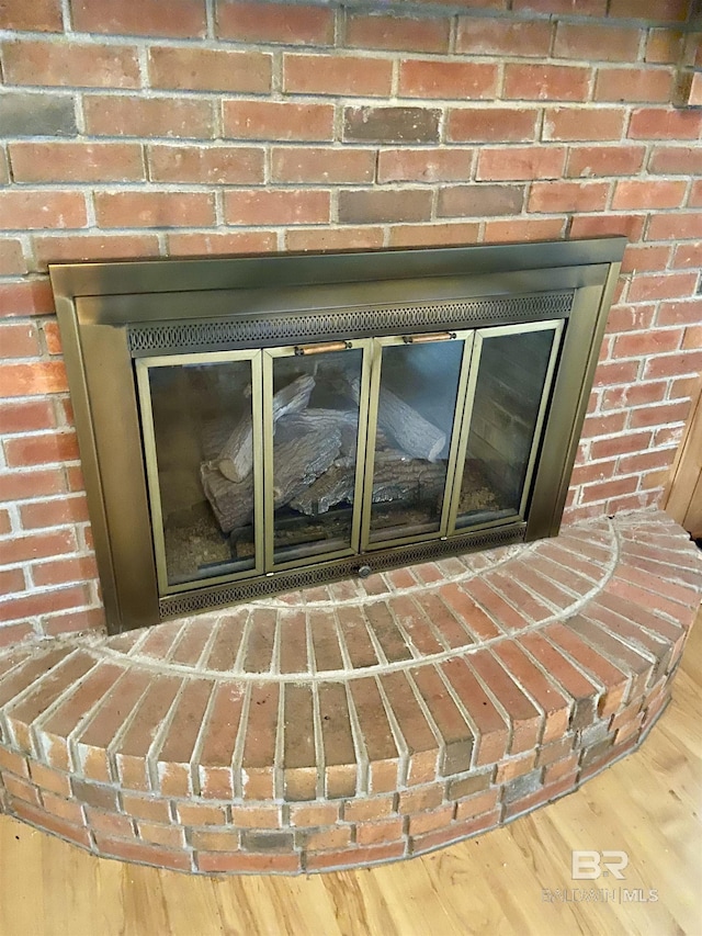 room details featuring hardwood / wood-style floors and a fireplace