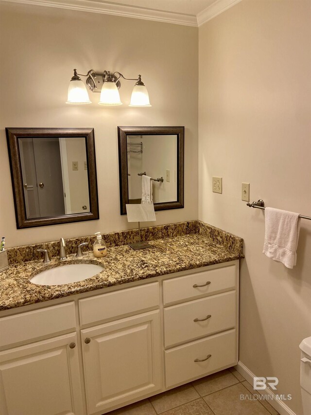 bathroom featuring vanity, crown molding, and tile patterned flooring