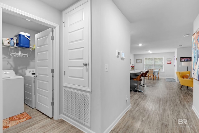 10804 Burlington Way, Mobile, AL 36608 - hallway featuring washing machine and clothes dryer and wood finished floors