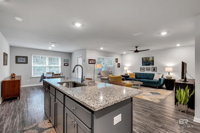 10804 Burlington Way, Mobile, AL 36608 - kitchen with a ceiling fan, dark wood-style flooring, a kitchen island with sink, light stone counters, and gray cabinets