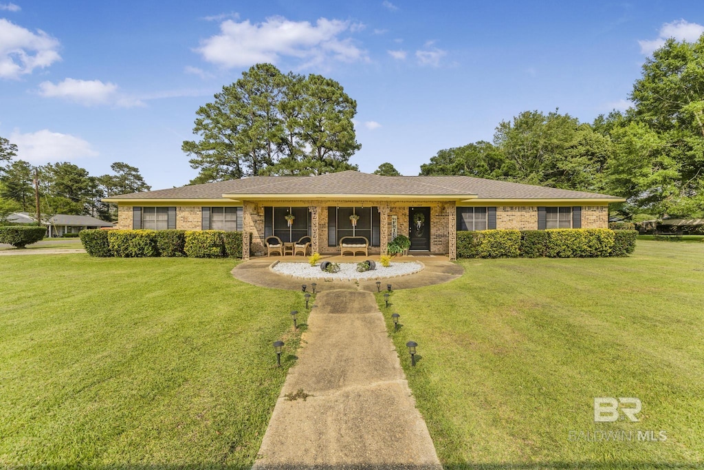 1312 N White Ave, Bay Minette, AL 36507 - single story home featuring a front yard, a porch, and brick siding