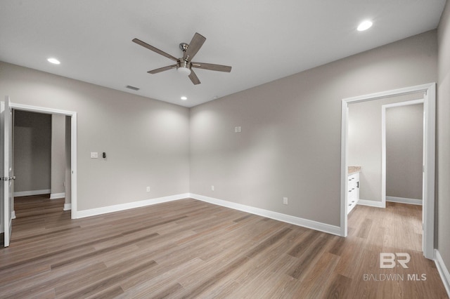 spare room featuring light hardwood / wood-style flooring and ceiling fan