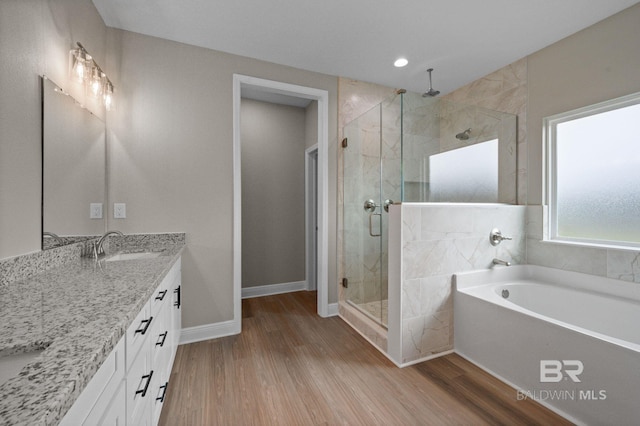 bathroom featuring vanity, hardwood / wood-style flooring, and independent shower and bath