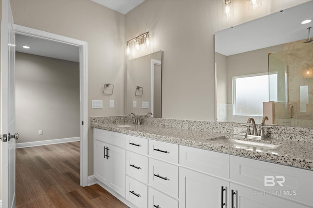 bathroom with vanity, wood-type flooring, and a shower with shower door