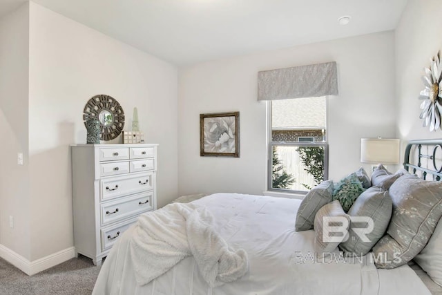 carpeted bedroom featuring baseboards