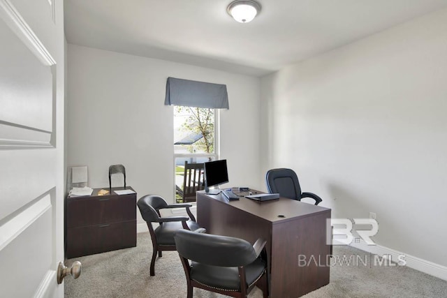 carpeted office featuring baseboards