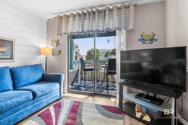 728 W Beach Blvd Unit 104, Gulf Shores, AL 36542 - living room featuring wooden walls and wood finished floors