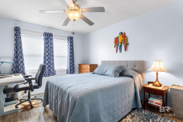 728 W Beach Blvd Unit 104, Gulf Shores, AL 36542 - bedroom with ceiling fan and wood finished floors
