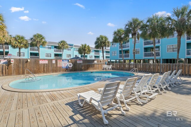 728 W Beach Blvd Unit 104, Gulf Shores, AL 36542 - community pool featuring a deck and fence