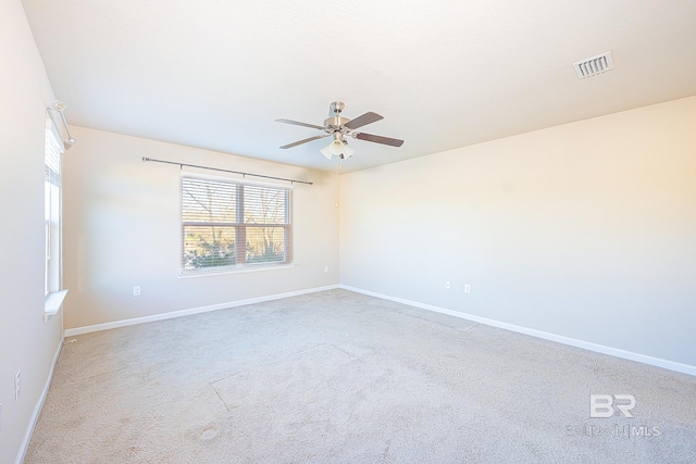 spare room with light carpet and ceiling fan