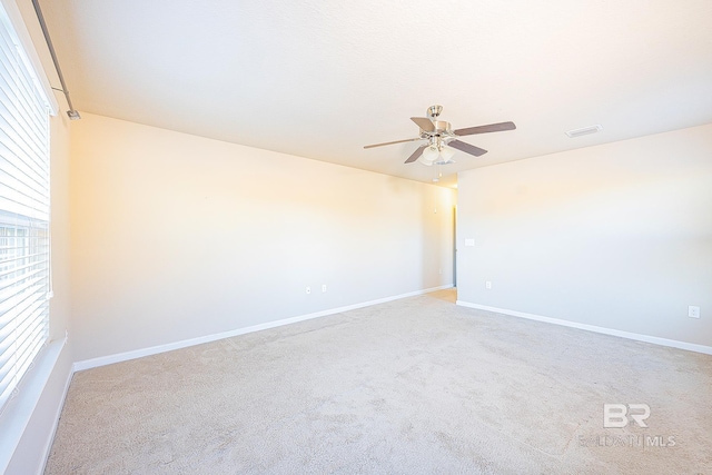 unfurnished room featuring ceiling fan and light colored carpet