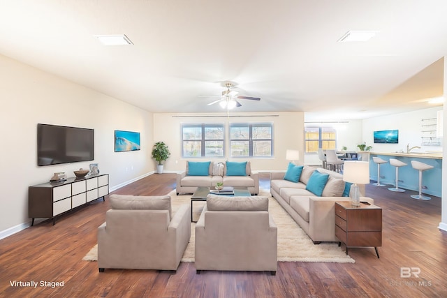 living room featuring hardwood / wood-style floors and ceiling fan