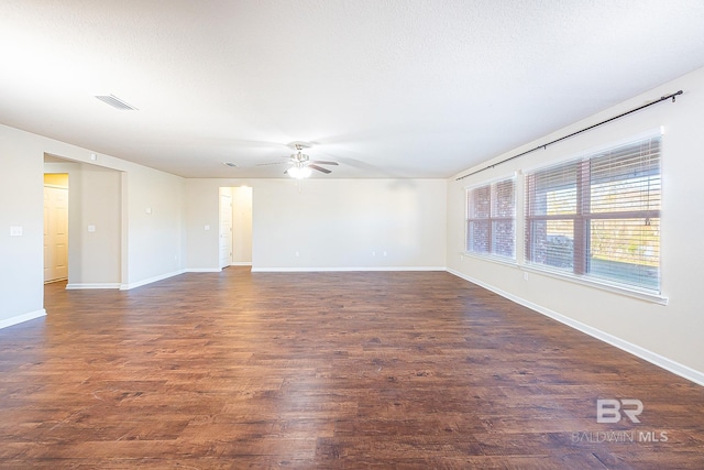 spare room with ceiling fan and dark hardwood / wood-style floors