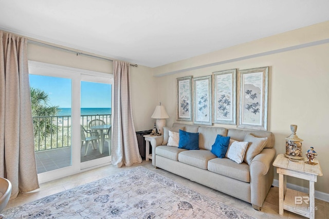 1117 W Beach Blvd Unit 201, Gulf Shores, AL 36542 - living room featuring tile patterned flooring and a water view