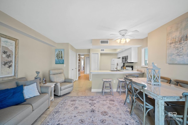 1117 W Beach Blvd Unit 201, Gulf Shores, AL 36542 - living room featuring a ceiling fan