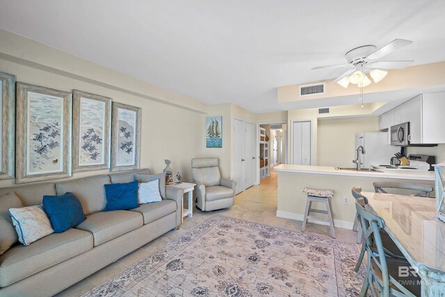 1117 W Beach Blvd Unit 201, Gulf Shores, AL 36542 - living area featuring ceiling fan and baseboards
