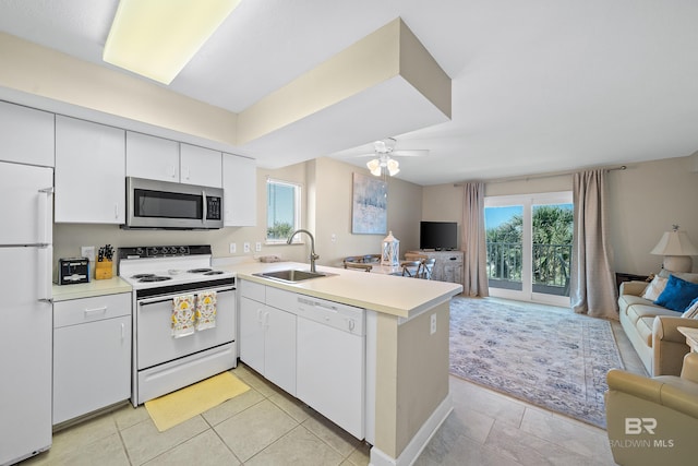 1117 W Beach Blvd Unit 201, Gulf Shores, AL 36542 - kitchen featuring white appliances, open floor plan, a sink, and a peninsula