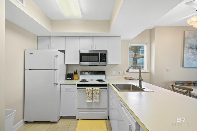 1117 W Beach Blvd Unit 201, Gulf Shores, AL 36542 - kitchen with white appliances, a sink, light countertops, white cabinets, and light tile patterned floors