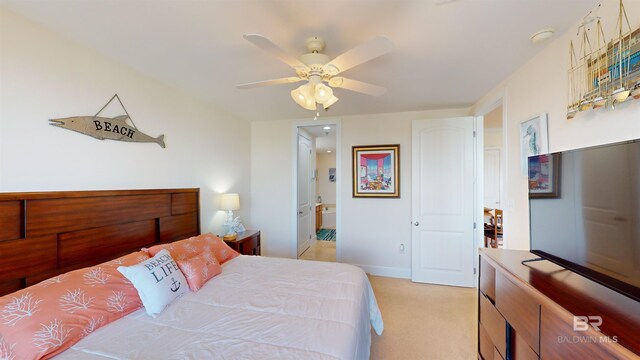 carpeted bedroom with connected bathroom and ceiling fan