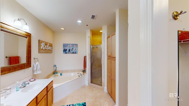 bathroom with vanity and shower with separate bathtub