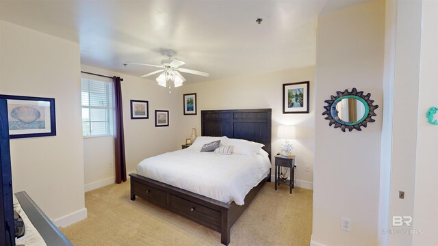 bedroom with ceiling fan and light colored carpet