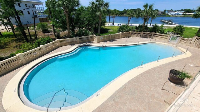 view of pool with a water view