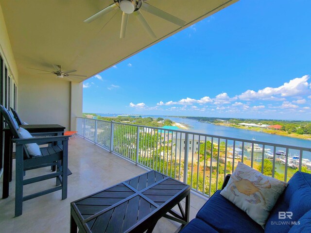 balcony featuring ceiling fan and a water view