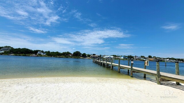 dock area with a view of the beach and a water view