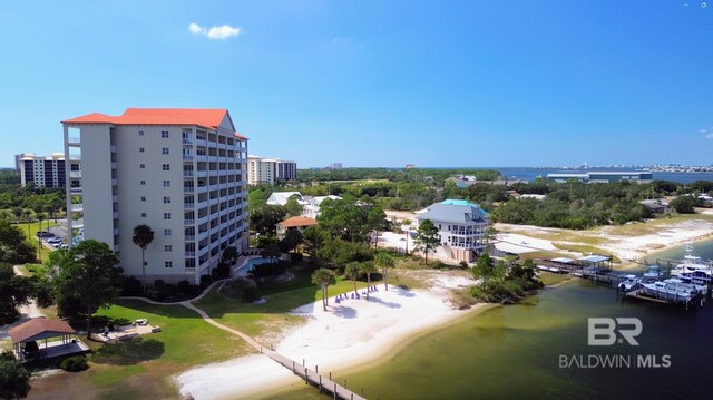 aerial view with a water view and a beach view