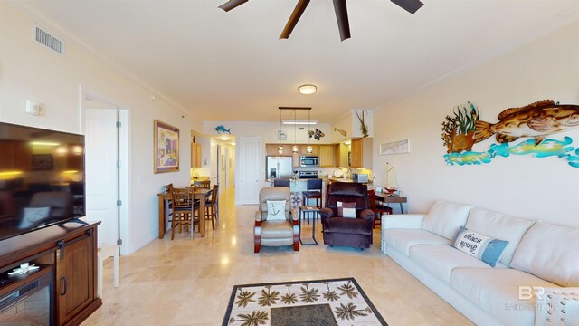 living room with crown molding and ceiling fan