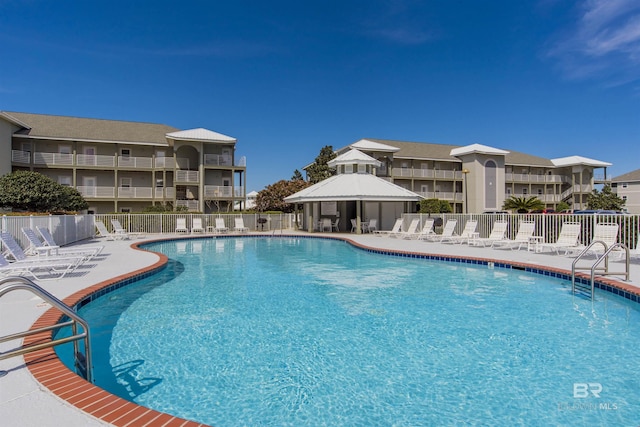 pool featuring a gazebo, a patio area, and fence