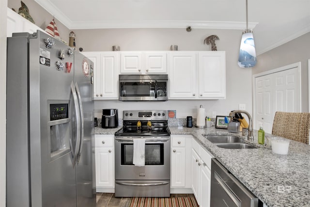 kitchen featuring appliances with stainless steel finishes, a sink, white cabinetry, and crown molding